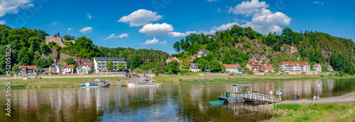 Panoramic view over monumental Bastei sandstone pillars and ferry docks over Elbe river at Kurort Rathen village in the national park Saxon Switzerland by Dresden and Czechish border, Saxony, Germany.