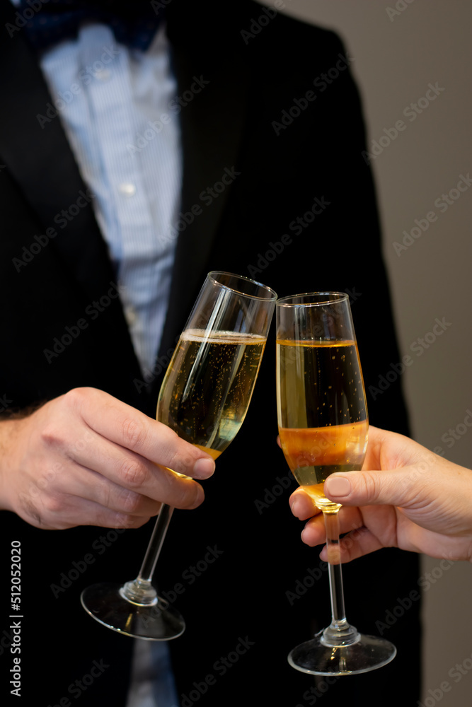 Cropped close-up toasting celebration two glasses with sparkling champagne wine in hands