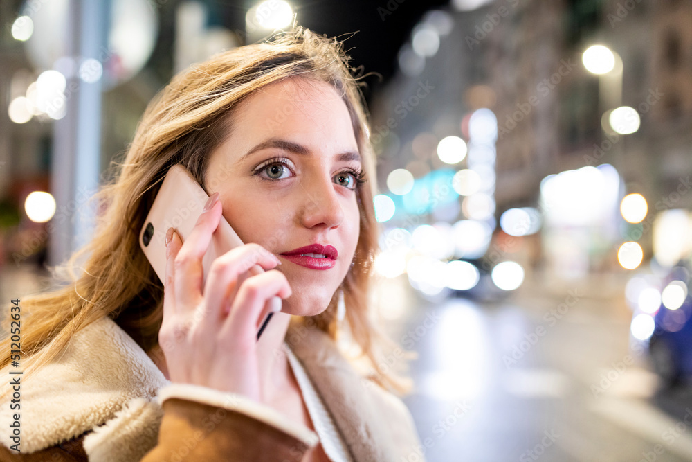 Young woman talking on smart phone in city Young woman talking on smart phone in city