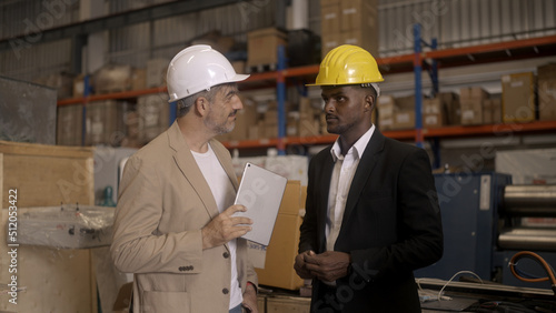 Businessman checking warehouse with staff