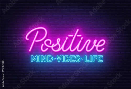 Positive Mind Vibes Life neon quote on a brick wall.