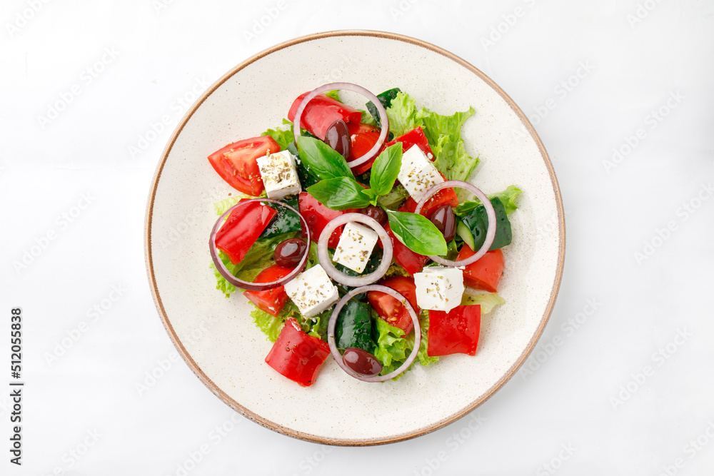 Vegetable salad with fetta cheese and onion on a white background Vegetable salad with fetta cheese and onion on a white background