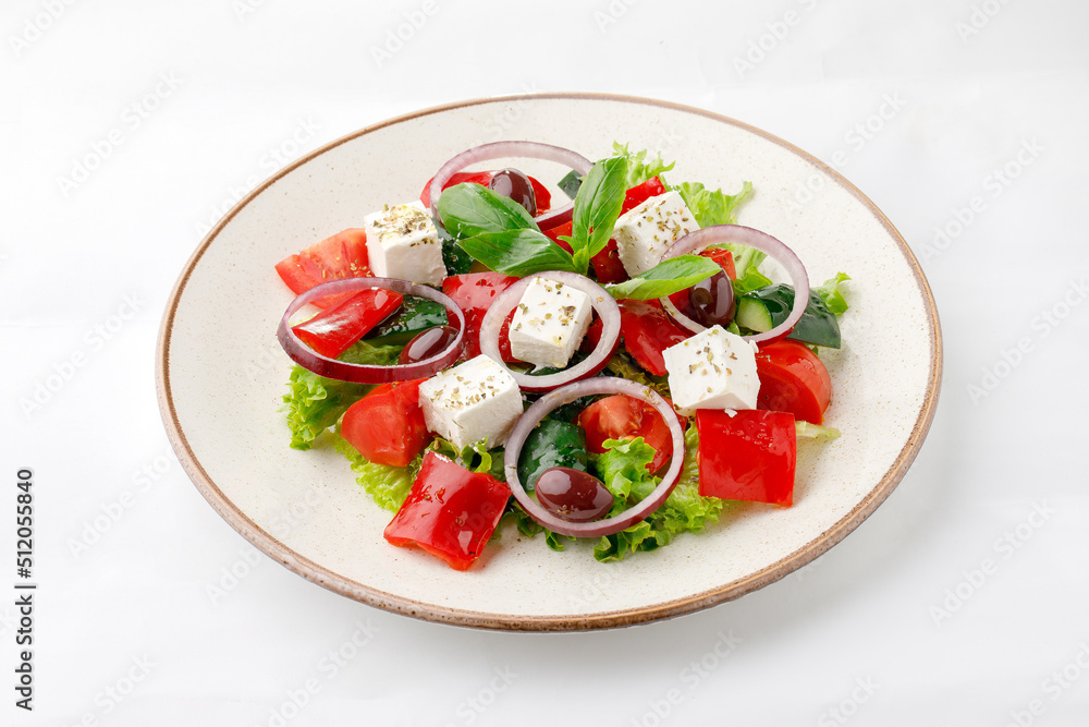 Vegetable salad with fetta cheese and onion on a white background Vegetable salad with fetta cheese and onion on a white background