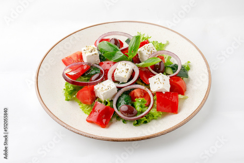 Vegetable salad with fetta cheese and onion on a white background