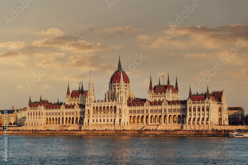 Orszaghaz Parliament neo-Gothic building and River Danube view at sunset, with clouds above, UNESCO World Heritage Site, Budapest, Hungary photo