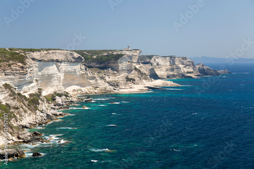 View along rugged limestone cliffs to Capo Pertusato and the distant coast of Sardinia, Bonifacio, Corse-du-Sud photo