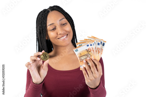Black woman with some fifty euro bills shows a bitcoin on a white background