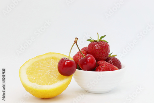 Yellow lemon and berries on a white background