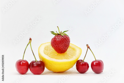 Yellow lemon and berries on a white background