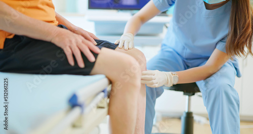 doctor examining patient knee © ryanking999