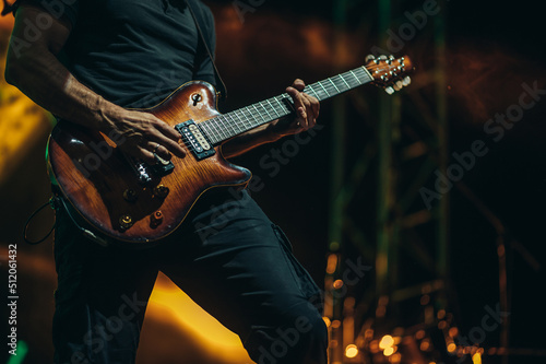Musician playing guitar on a stage