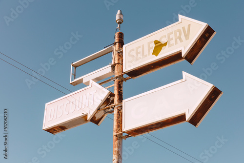 Self Serve sign, three arrows on an elevated roadside sign.