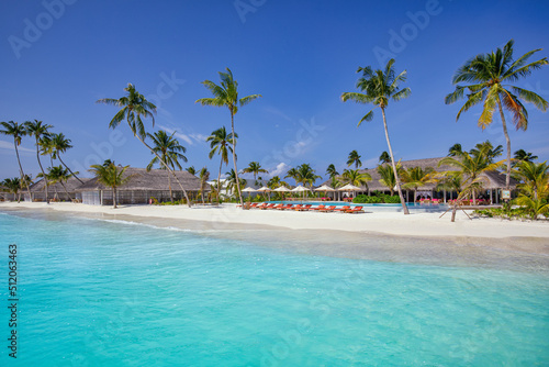 Fototapeta Naklejka Na Ścianę i Meble -  Outdoor tourism landscape. Luxurious beach resort with swimming pool and beach chairs or loungers under umbrellas with palm trees, sunny sky. Summer travel and vacation background concept