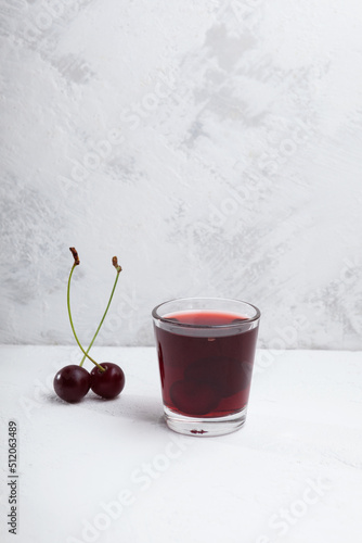 Ginjinha or Ginja. Portuguese liqueur made by infusing ginja berries (sour cherry, Prunus cerasus austera, Morello cherry) in alcohol and adding sugar photo