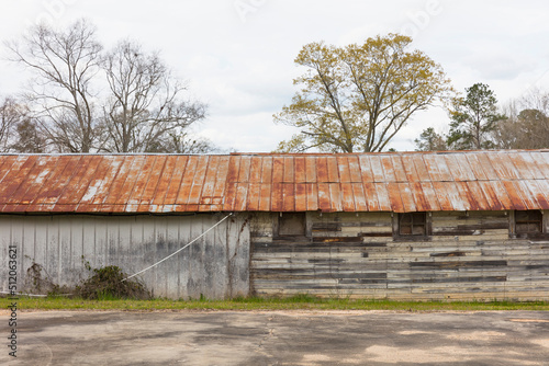 Old barn and warehouse with a rusting roof.