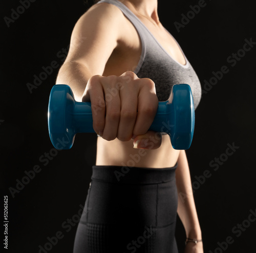 Close up image of healthy girl performing exercise on the black background