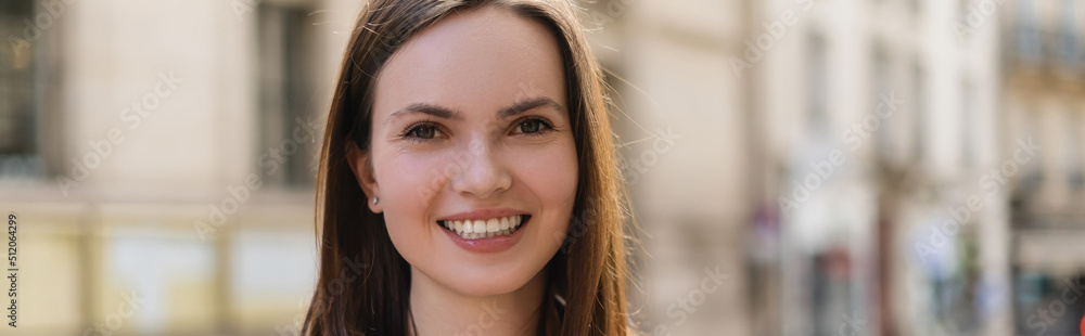 portrait of happy young woman smiling while looking at camera, banner. portrait of happy young woman smiling while looking at camera, banner.
