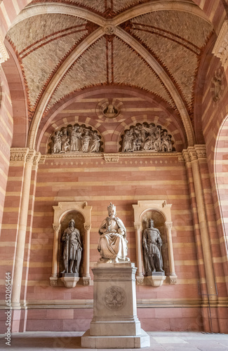 Nice full view of a statue of King Rudolf I of Habsburg in the narthex of the famous Speyer Cathedral in Rhineland-Palatinate, Germany. The monument shows the ruler sitting on a throne with his crown.