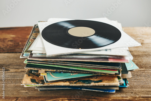 Stack of vinyl records. Listening to music from record. Playing music from analog disk. Retro and vintage. Audio stereo. Analog sound