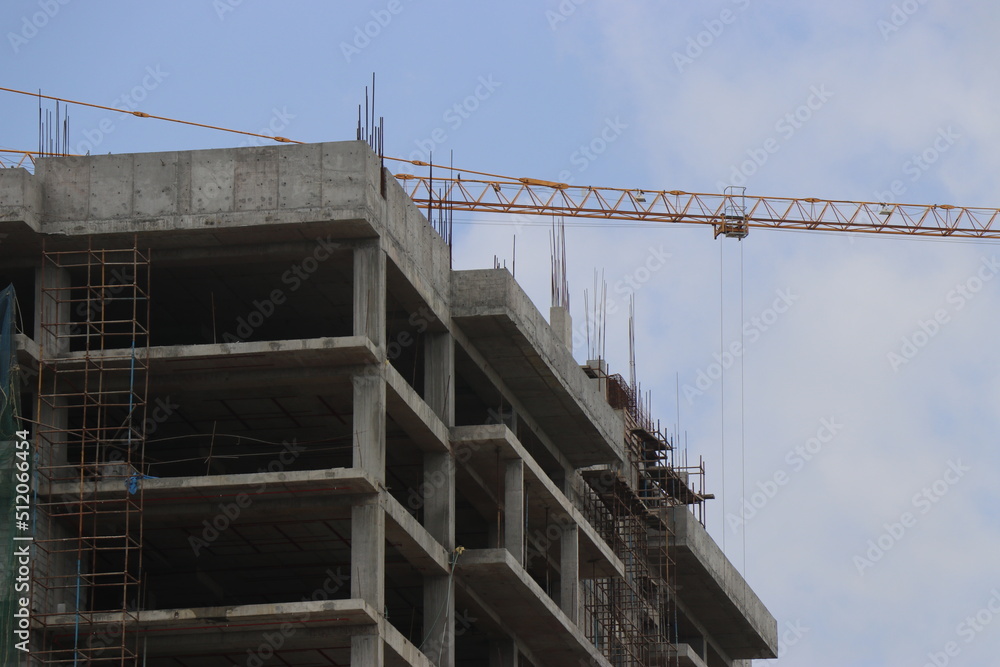 Construction of the new building with Cranes on the constructing site. Crane and building construction site against the sky Construction of the new building with Cranes on the constructing site. Crane and building construction site against the sky