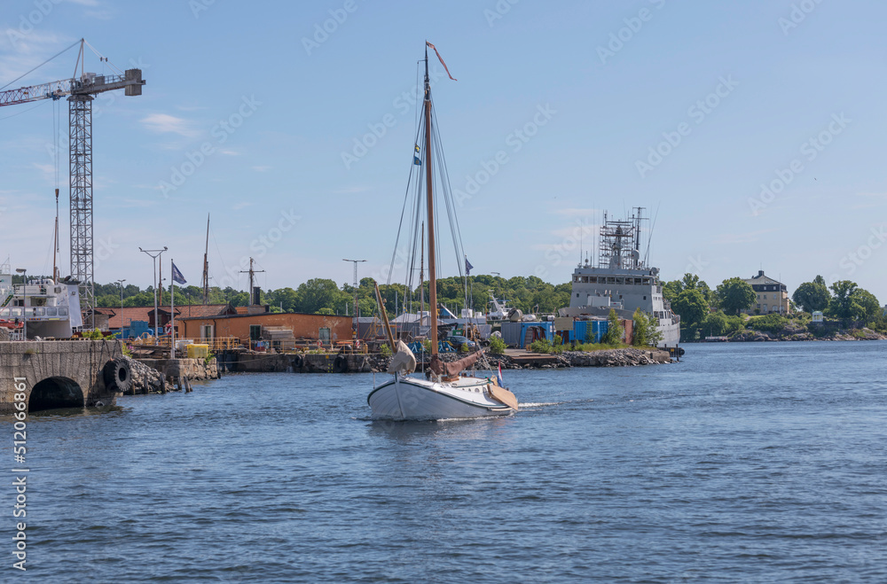 Sailing boat with a pivoting keel, leeboard, arriving a sunny summer day in Stockholm