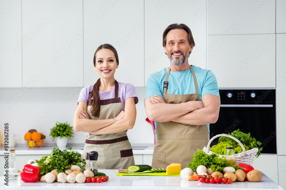 Photo of two cheerful positive people crossed hands have good mood prepare salad kitchen indoors Photo of two cheerful positive people crossed hands have good mood prepare salad kitchen indoors