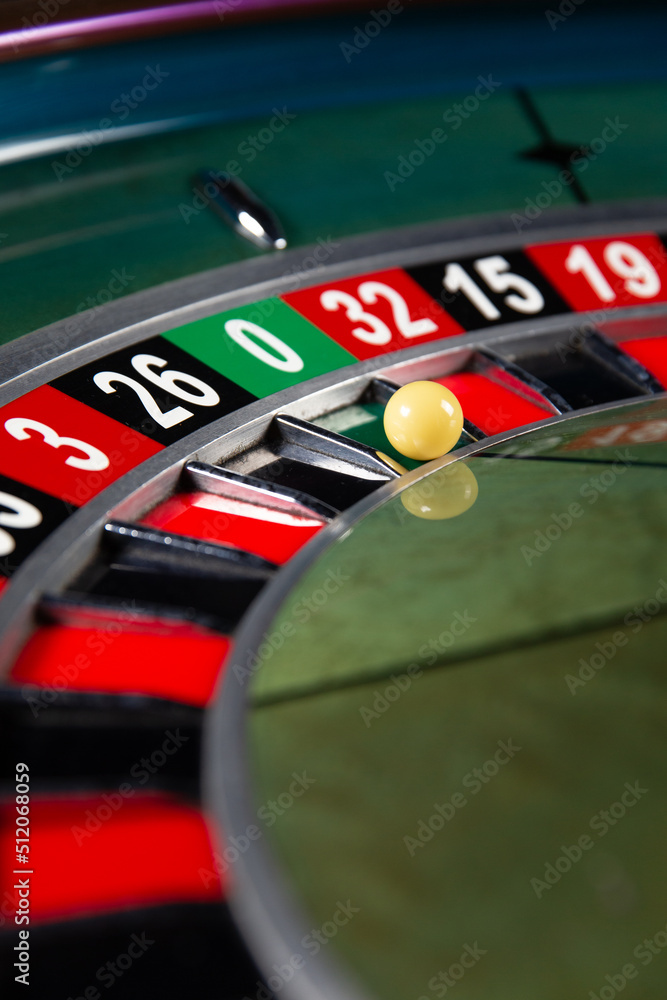 Obraz premium Image with casino roulette wheel with ball on number 0.