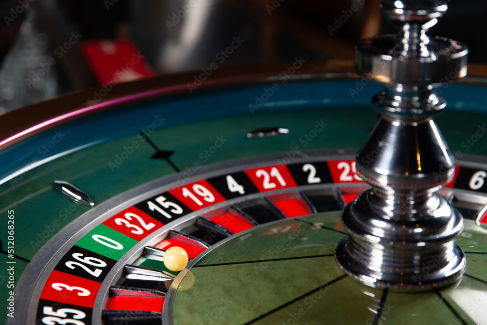 Image with casino roulette wheel with ball on number 0. Image with casino roulette wheel with ball on number 0.