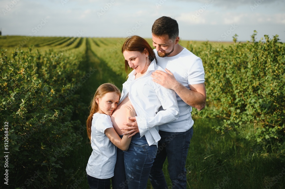Pregnant woman with her family looking happy Pregnant woman with her family looking happy