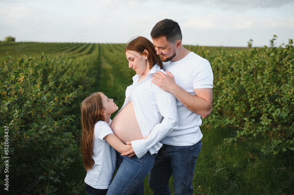 Pregnant woman with her family looking happy Pregnant woman with her family looking happy
