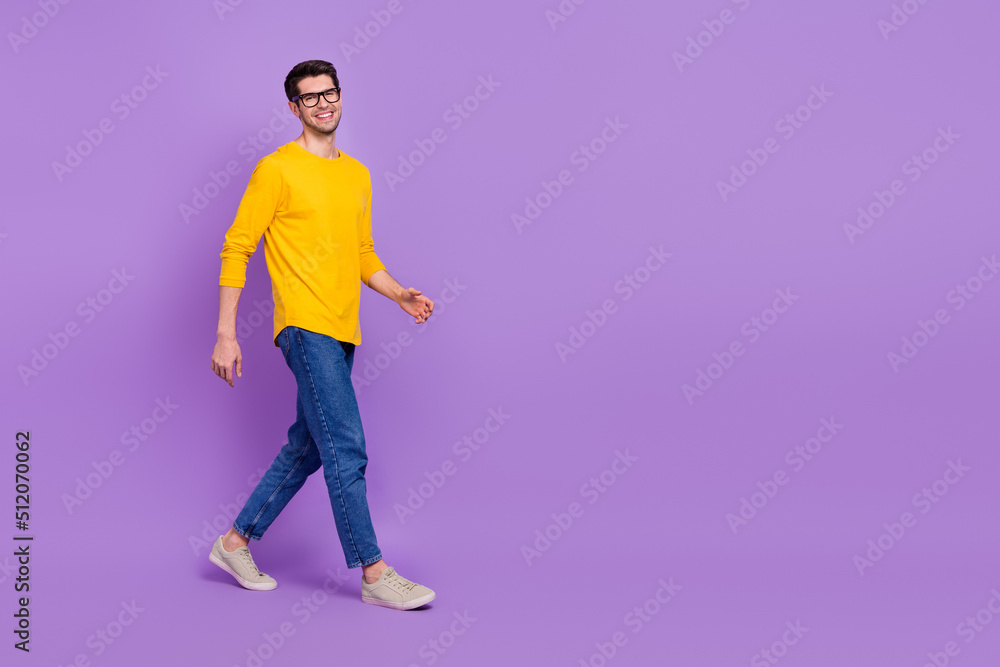 Full body image of happy handsome young man go on walk relax summer vacation isolated on violet color background Full body image of happy handsome young man go on walk relax summer vacation isolated on violet color background