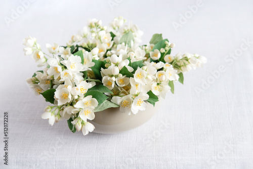 Beautiful flower arrangement. Jasmine flowers, free space for text on a light pastel background. Wedding, birthday. Valentine's day, mother's day. Top view, copy space