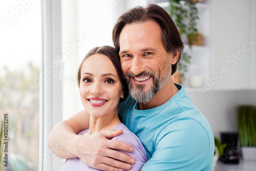 Portrait of two lovely cheerful peaceful people hug embrace toothy smile enjoy free time together house indoors #512072295