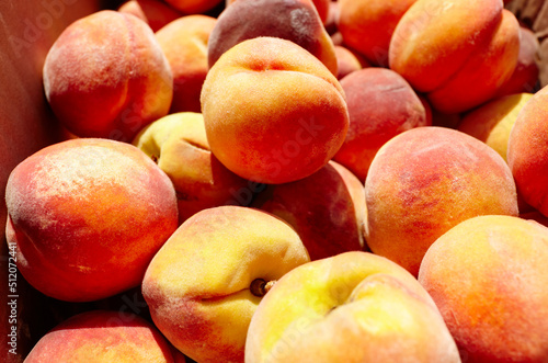Fresh ripe peaches as background from orchard, top view. Peaches in a cardboard box, closeup. Healthy food in fruit market