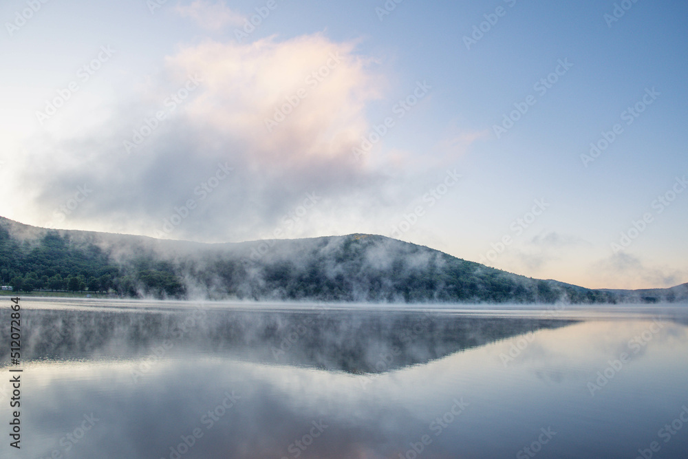 Morning fog over. a mountain lake, landscape vacation theme, summer.