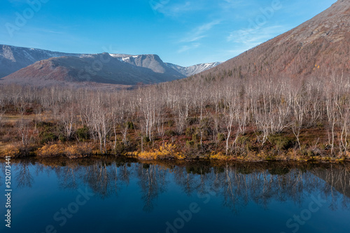 Blue mountain lake on the background mountain picks in polar autumn. Landscapes of Northern Nature. Nature regions of Russia