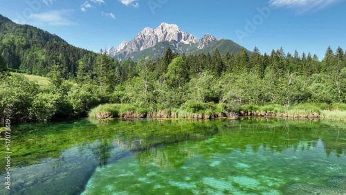 Zelenci springs in the Julian Alps on a summer day. Beautiful lake and mountains in the Slovenian countryside. photo