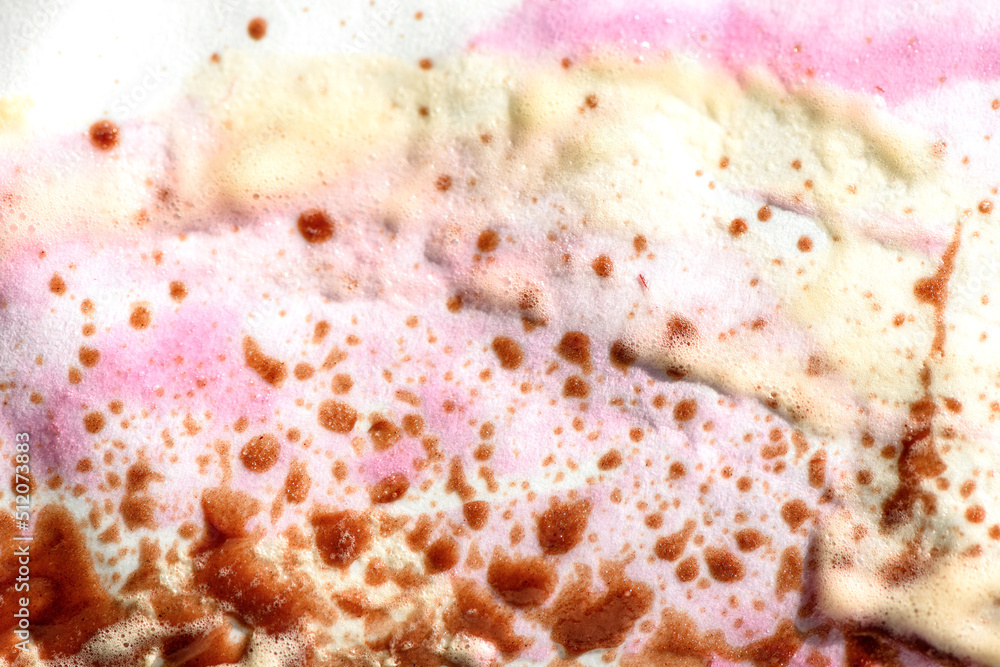 Abstract background of colorful drops of melted ice cream on paper wrapping paper.