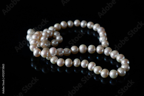 beautiful pearls necklace on black background