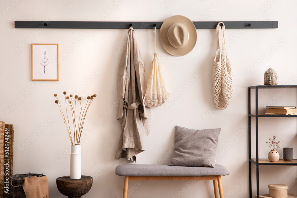 The stylish composition of cosy entryway with grey bench, coffee table,  hanger and personal accessories. Beige wall. Home decor. Template.  Stock-Foto | Adobe Stock