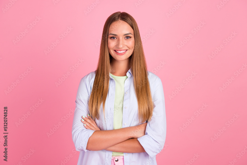 Photo of satisfied glad young girl crossed arms toothy beaming smile isolated on pink color background Photo of satisfied glad young girl crossed arms toothy beaming smile isolated on pink color background
