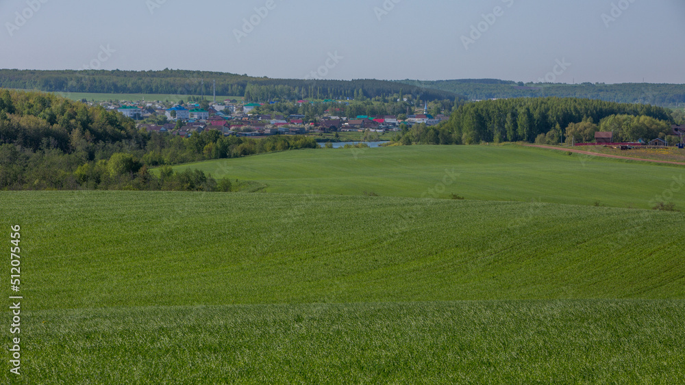 view of the village of Kalmash, Tatarstan, Russia, spring agricultural fields from the top of the hill on a spring clear morning
