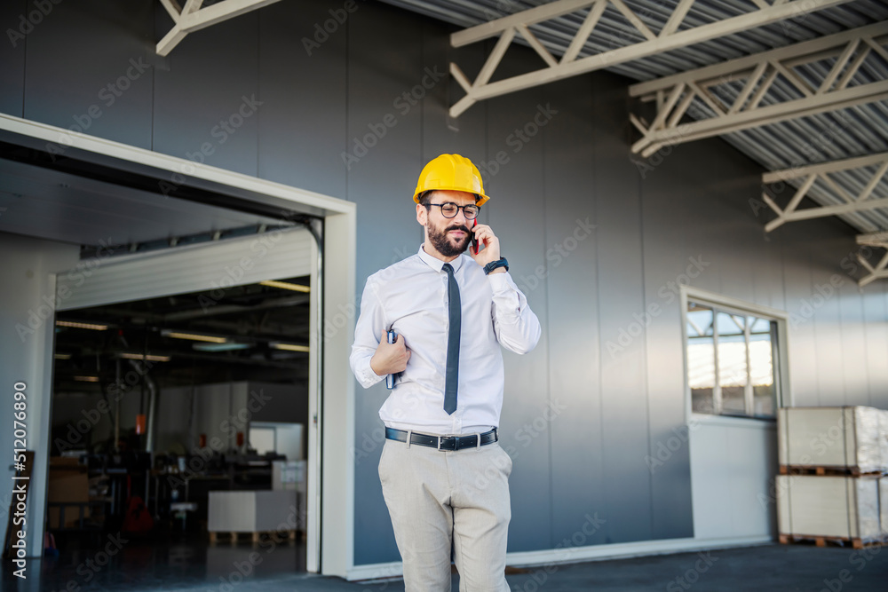 A printing shop inspector contacts clients on the phone. A printing shop inspector contacts clients on the phone.