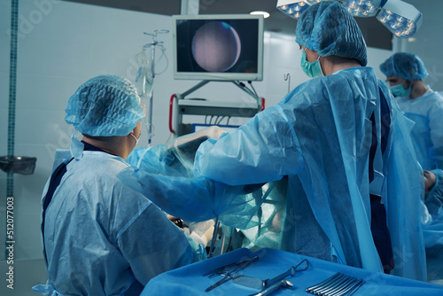 Doctors performing hysteroscopy procedure in the operating room photo