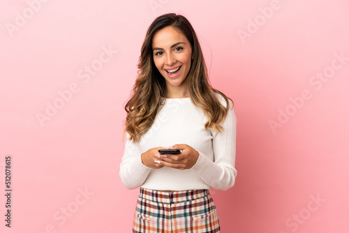 Young woman over isolated background surprised and sending a message