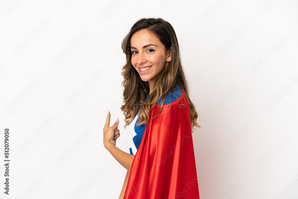 Super Hero woman over isolated white background pointing back