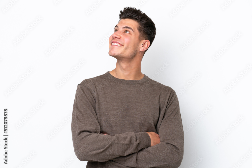 Young handsome caucasian man isolated on white bakcground looking up while smiling Young handsome caucasian man isolated on white bakcground looking up while smiling
