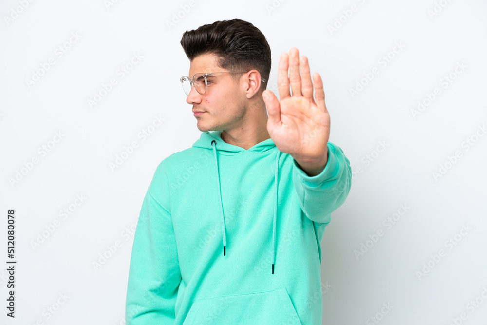 Young handsome caucasian man isolated on white bakcground making stop gesture and disappointed Young handsome caucasian man isolated on white bakcground making stop gesture and disappointed