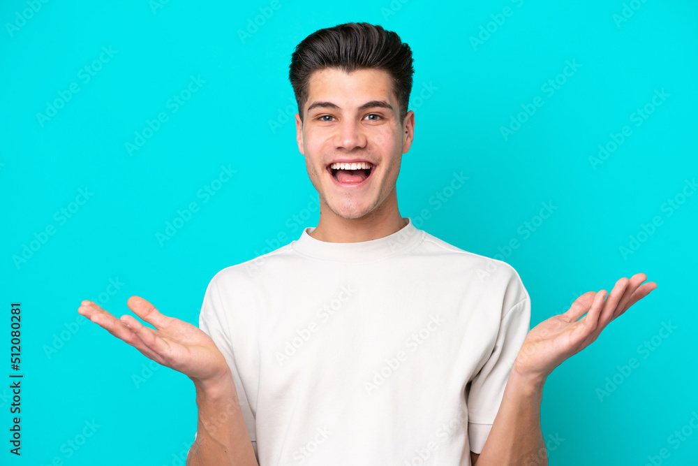 Young handsome caucasian man isolated on blue bakcground with shocked facial expression Young handsome caucasian man isolated on blue bakcground with shocked facial expression