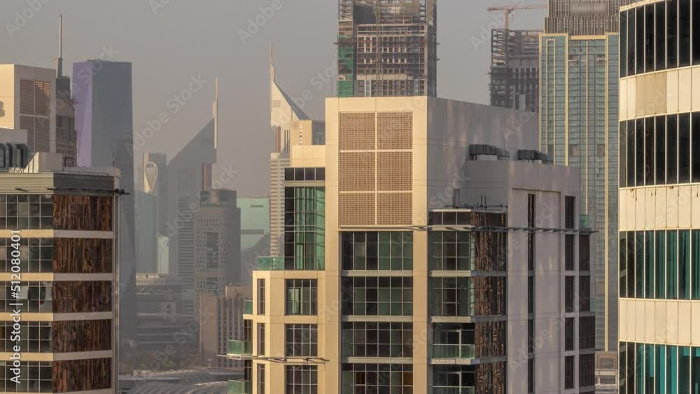 Skyscrapers in Dubai Business Bay and financial district aerial timelapse. Skyline with office towers and construction site at evening Skyscrapers in Dubai Business Bay and financial district aerial timelapse. Skyline with office towers and construction site at evening